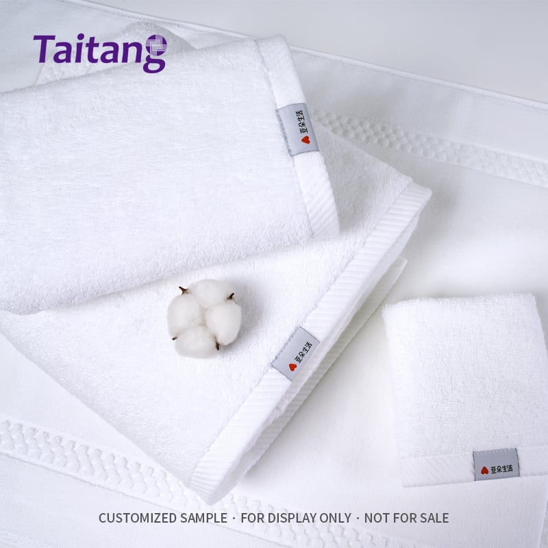 1. Taitang premium hotel white towels set displayed with natural raw cotton boll showing cotton purity.jpg