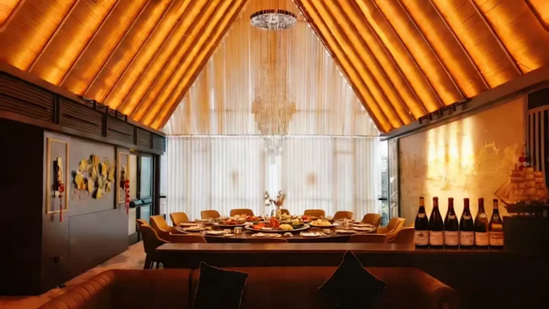High-end private dining suite featuring a large round banquet table set with linens and modern architectural lighting.webp