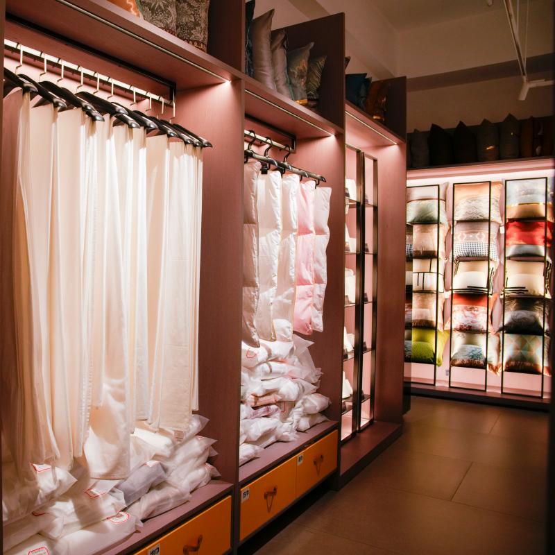Detailed display of hanging hotel textiles, including window curtains, blackout drapes, and sheer fabrics, in Taitang’s product showroom.JPG