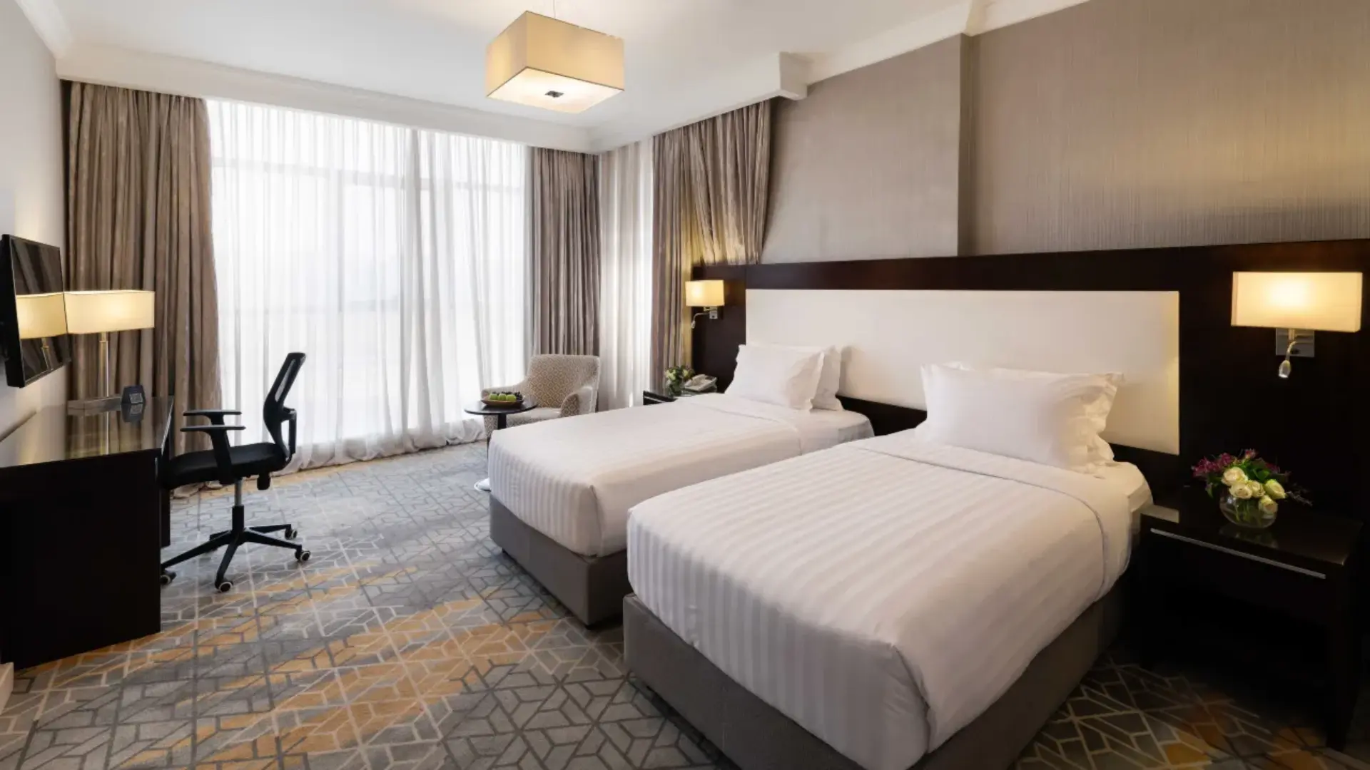 Executive twin bedroom interior at Warwick Hotel Jeddah, featuring two single beds neatly made with Taitang's premium white striped hospitality linens.webp