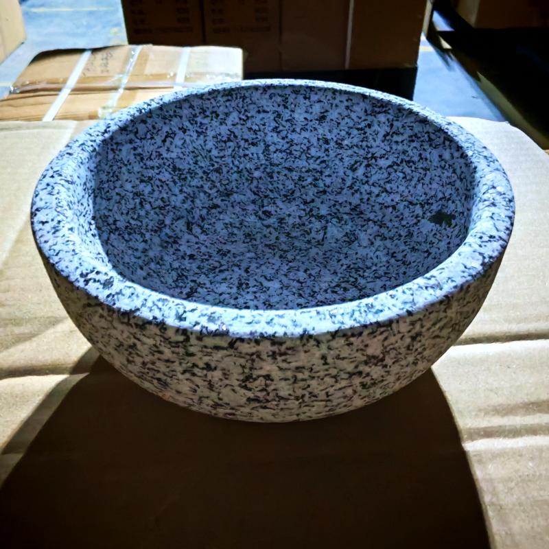 Heavy-duty natural granite stone bowl sample undergoing quality inspection on shipping packaging.jpg