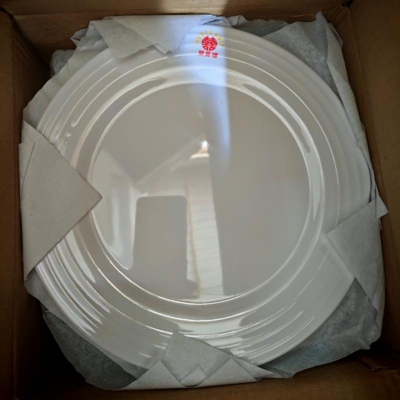 Custom printed white ceramic plates with red restaurant logo decal packed in protective shipping carton for restaurant delivery.jpg