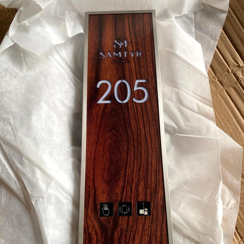 Custom faux-wood-grain electronic hotel room signplate for Room 205 with touch-capacitive doorbell and LED indicators.JPG