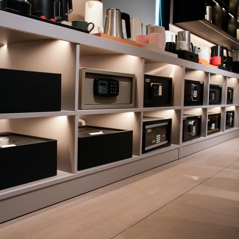 A commercial showroom display of Taitang motorized electronic hotel room safes and top-opening drawer safe boxes for wholesale hospitality procurement.JPG