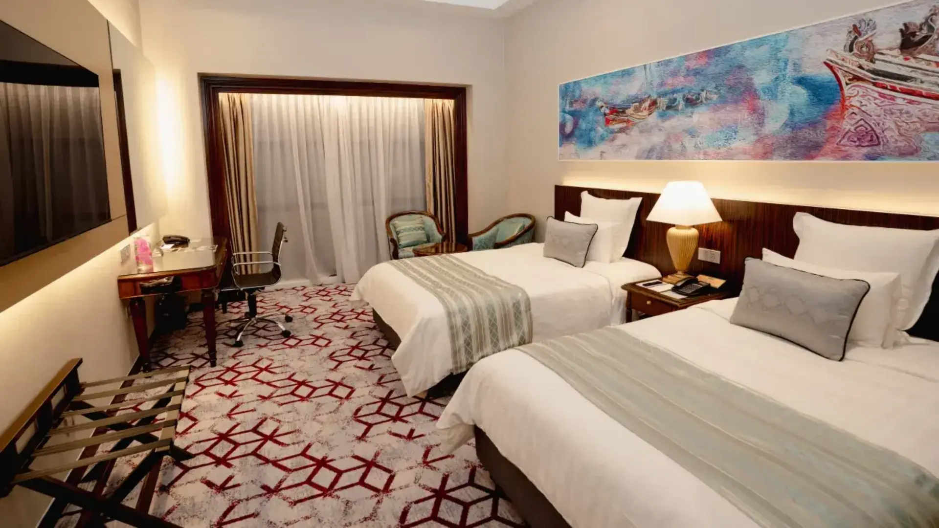 Modern luxury 5-star twin guest room interior at Renai Hotel Kota Bharu, featuring two beds meticulously dressed in crisp white sheets, elegant grey patterned bed runners, and plush supportive pillows.webp