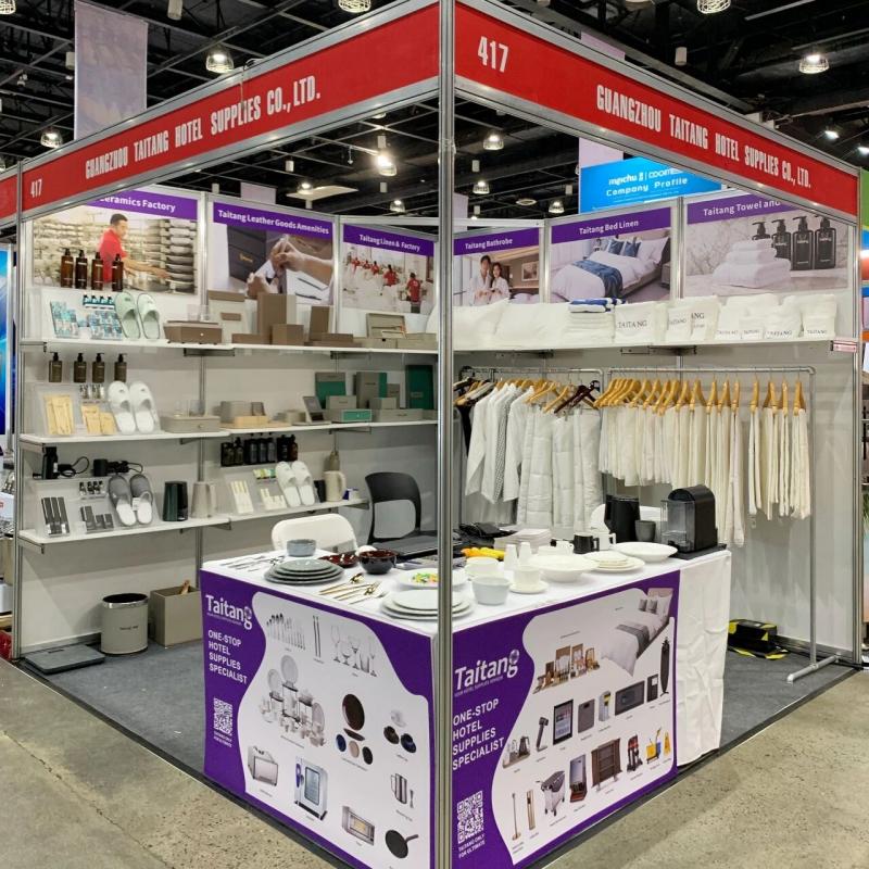 Wide view of Taitang's comprehensive hotel OS&E exhibition booth featuring commercial dinnerware, luxury guestroom linens, and amenities..jpg