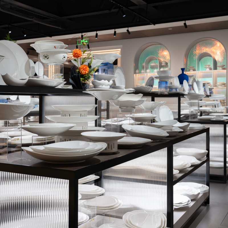 Taitang commercial grade white porcelain dinnerware collections and plates displayed on modern showroom racks for luxury hotel F&B procurement.jpg