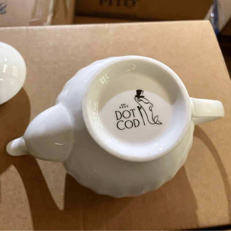 Bottom base of white ceramic teapot showing custom-fired Dot Cod logo backstamp for brand customization.JPG
