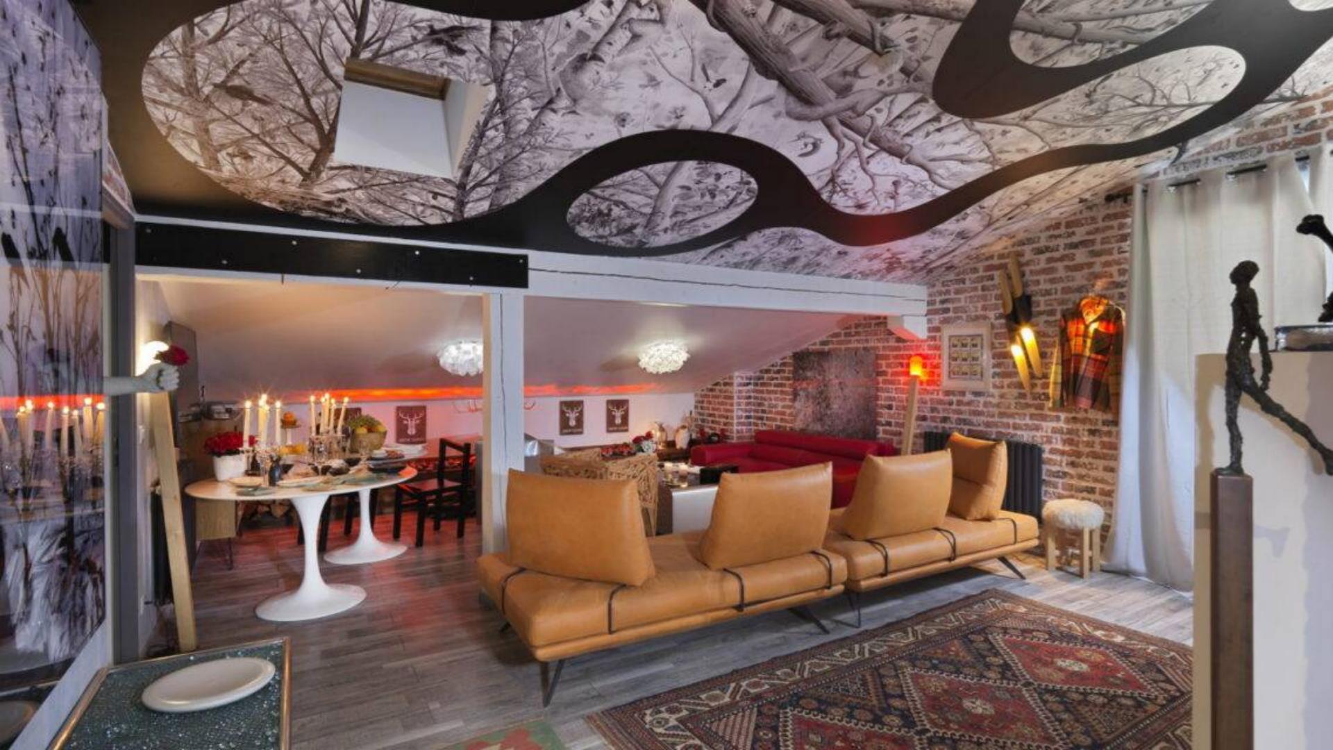 Artistic luxury hotel lobby and lounge area at Snow Lodge featuring cozy leather sofas, brick walls, and premium interior decor for upscale ski resort guests.jpg