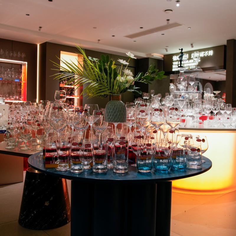 Taitang commercial glassware collection displayed on an illuminated table in a modern hotel tableware showroom.JPG