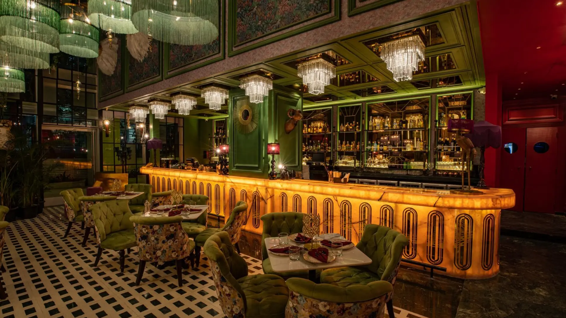 Upscale restaurant bar lounge with an illuminated onyx bar counter and ambient dining seating.webp