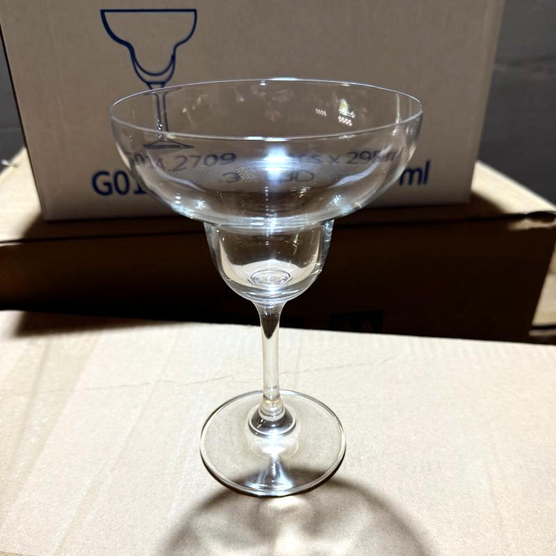 Clear glass margarita cocktail goblet inspected on shipping packaging for hotel bar supplies.jpg