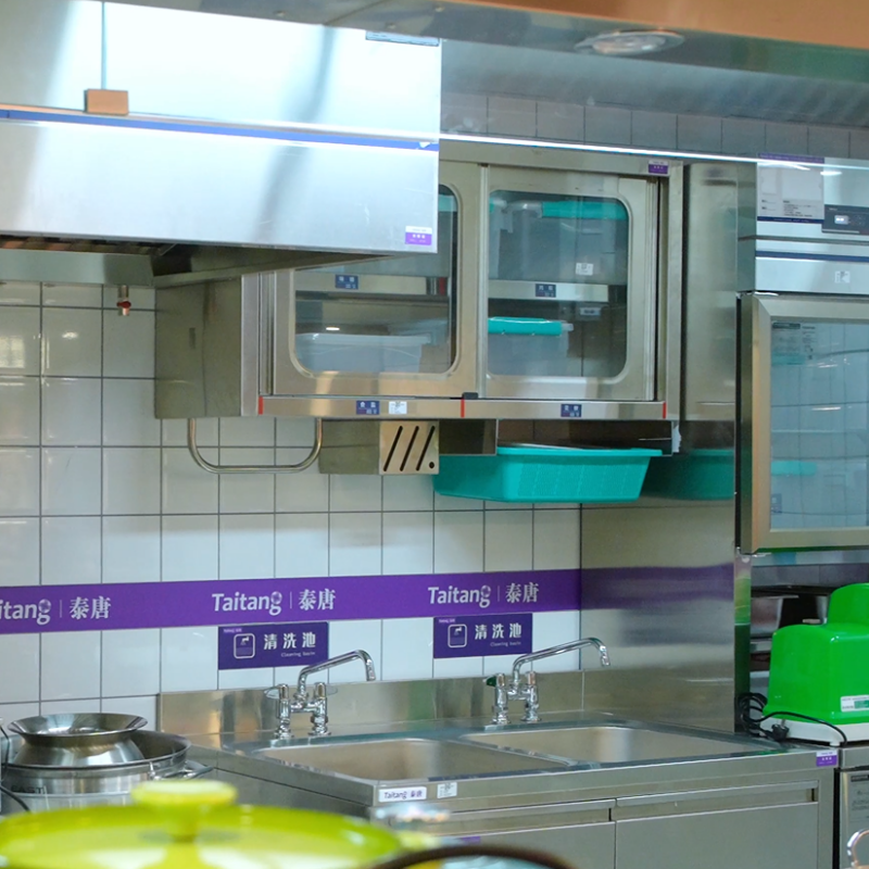 Taitang live cooking station featuring integrated double stainless steel sinks, wall cabinets, and open prep counters..png