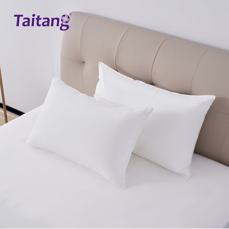 Top-down perspective of plush commercial pillows showing volume and large 50x80cm dimensions.jpg