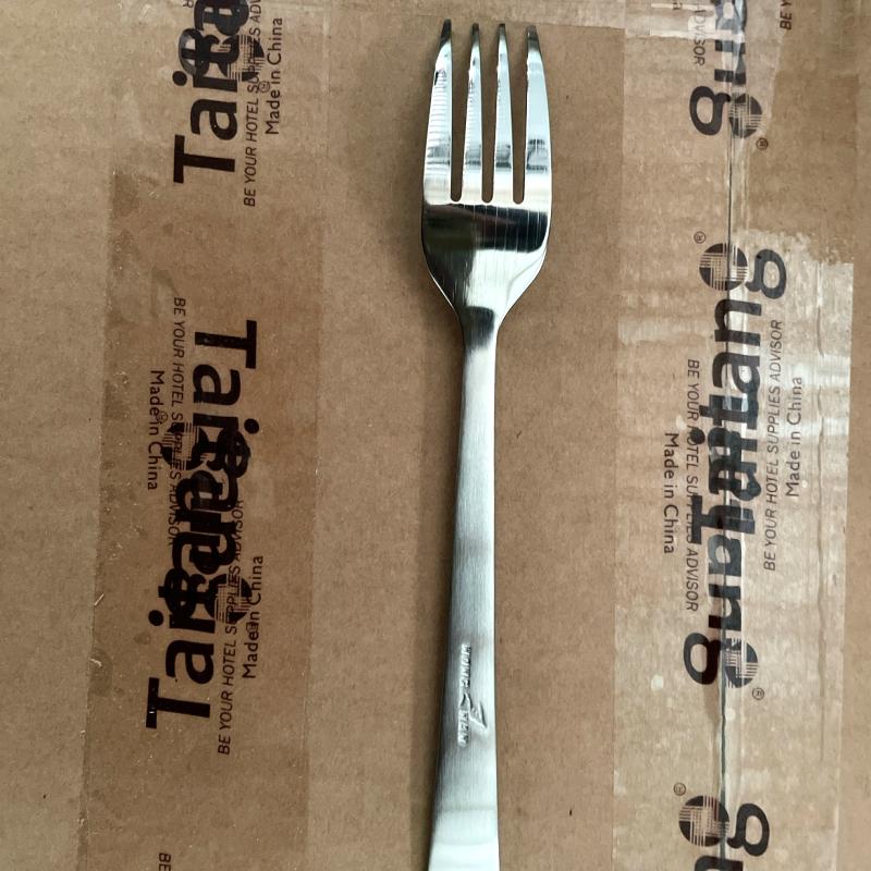 Heavy-duty stainless steel commercial dinner fork set on Taitang branded packaging during factory inspection.JPG