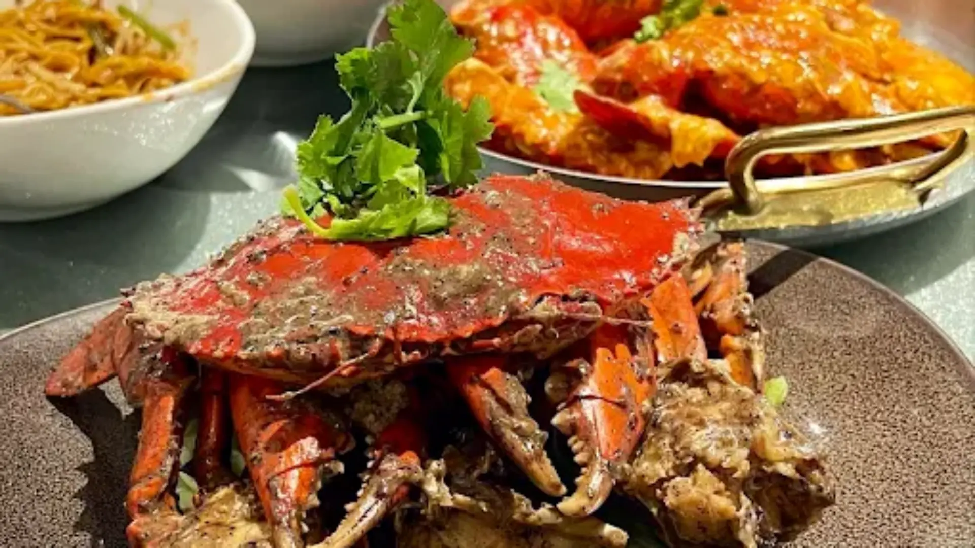 Signature Singapore chili crab seafood dish elegantly served on heavy-duty commercial ceramic tableware.webp
