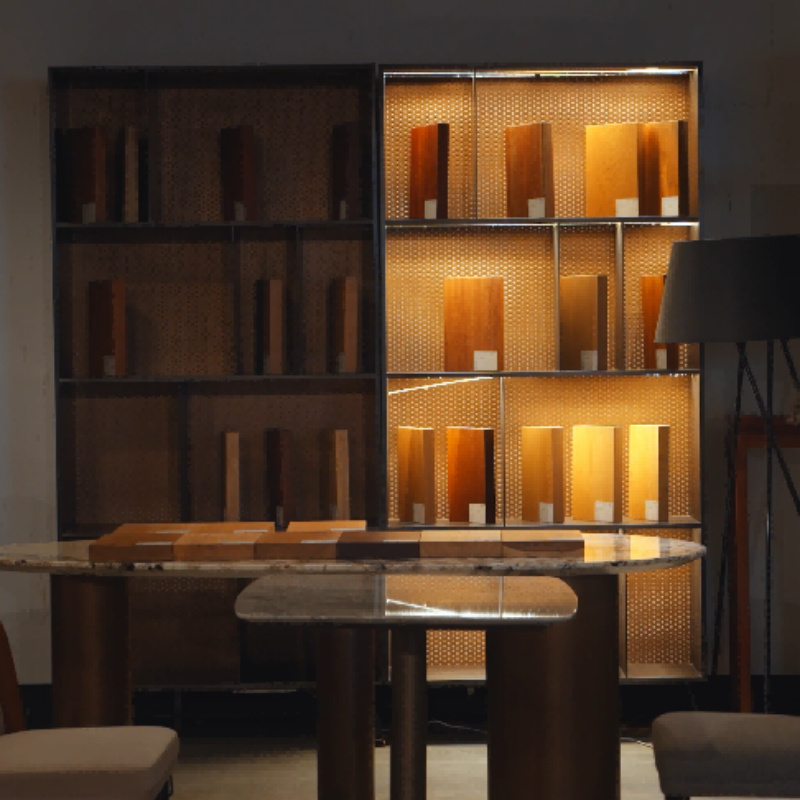 A detailed close-up of custom-backlit display cabinetry in a premium hotel meeting room, illustrating how integrated lighting and custom woodwork create a high-end experience.png
