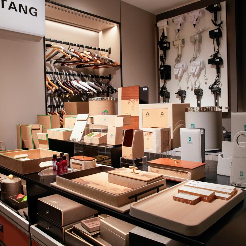 A wide-angle shot in Taitang’s showroom focusing on various high-quality wooden and leatherette hotel guest room accessory trays and organization solutions.JPG