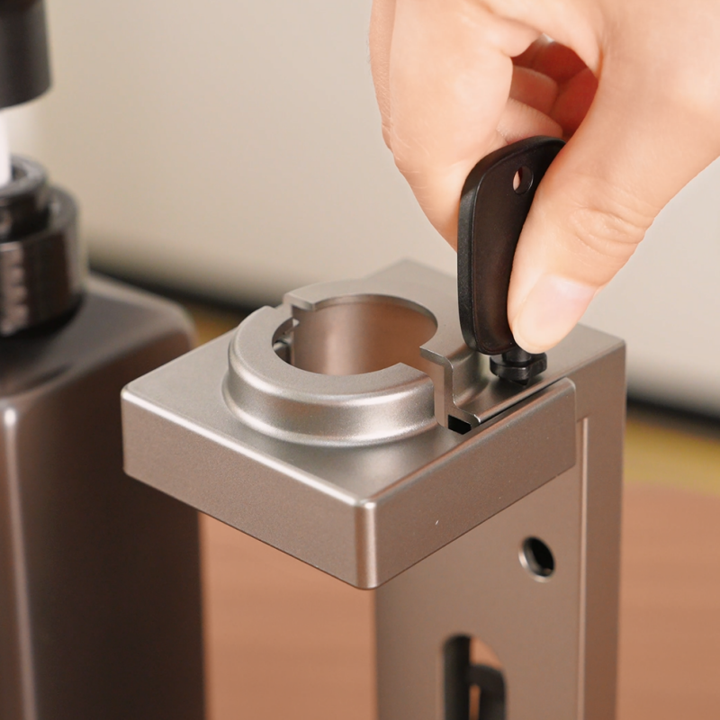 Housekeeping key unlocking the tamper-proof security bracket of a Taitang commercial wall-mounted hotel soap dispenser.png