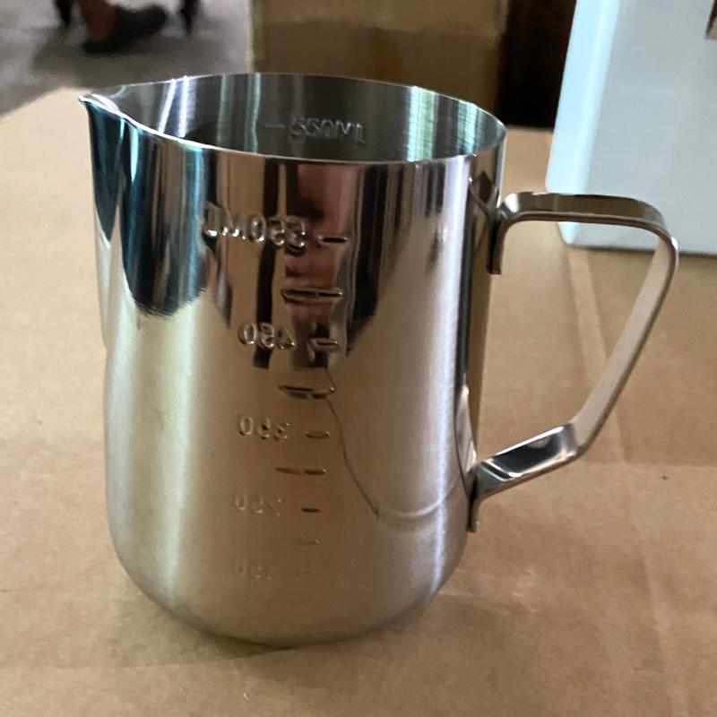 Commercial stainless steel milk frothing pitcher with interior measurement lines for hotel barista service.JPG