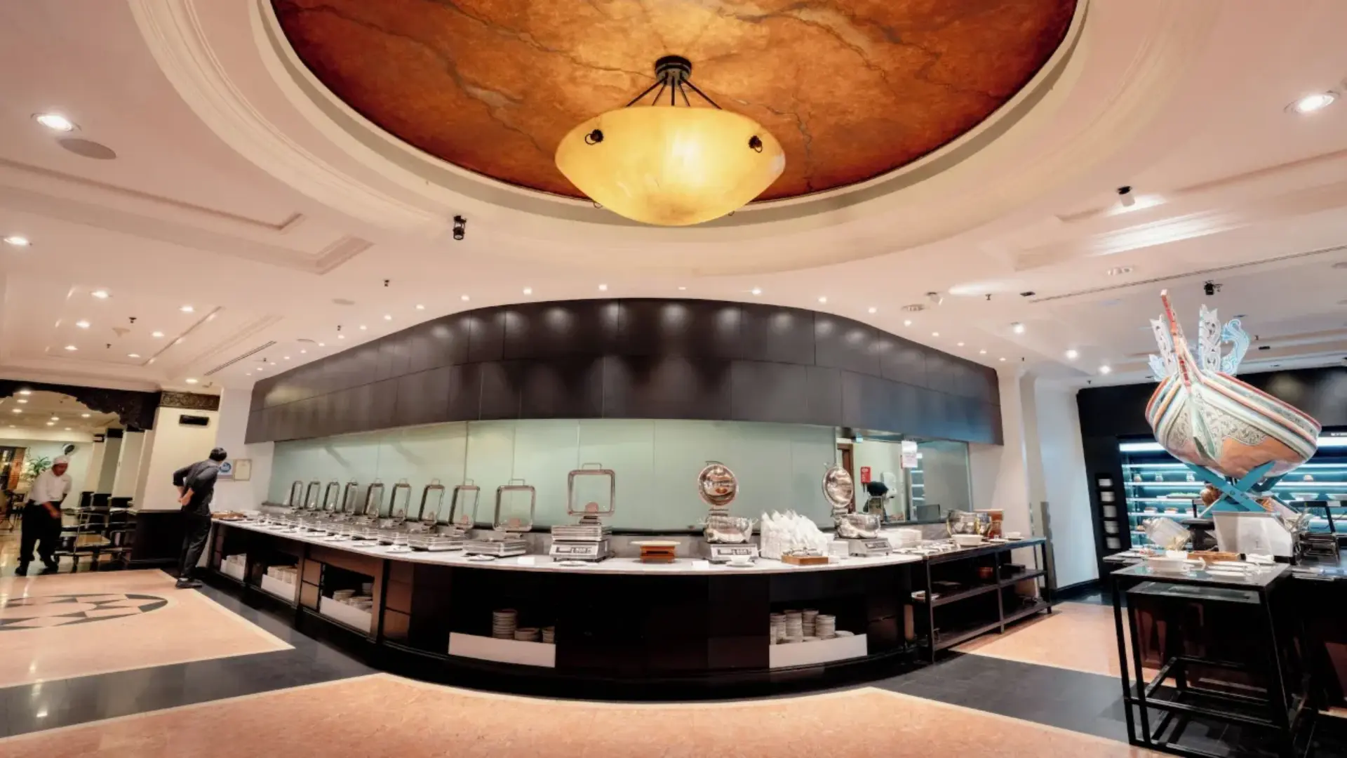 Grand commercial hotel buffet station layout featuring a sweeping curved counter lined with heavy-duty stainless steel chafing dishes, showcasing Taitang’s wholesale commercial buffetware for luxury hotels.webp
