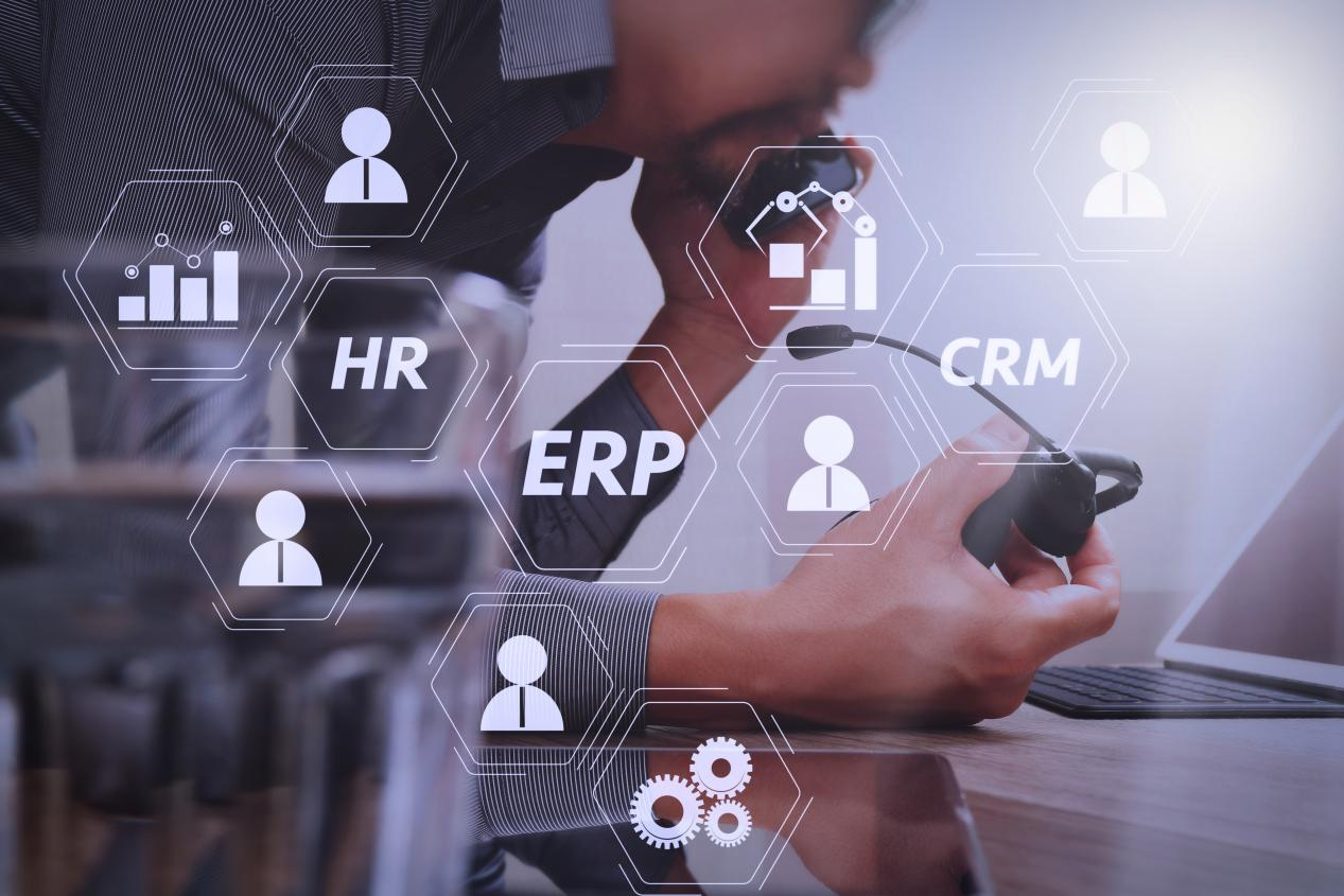 An overlay infographic featuring key business terms: ERP, HR, CRM, and person icons connected by lines over an ambiguous figure with a headlamp, illustrating the integrated digital enterprise resource planning system behind Taitang’s delivery service.