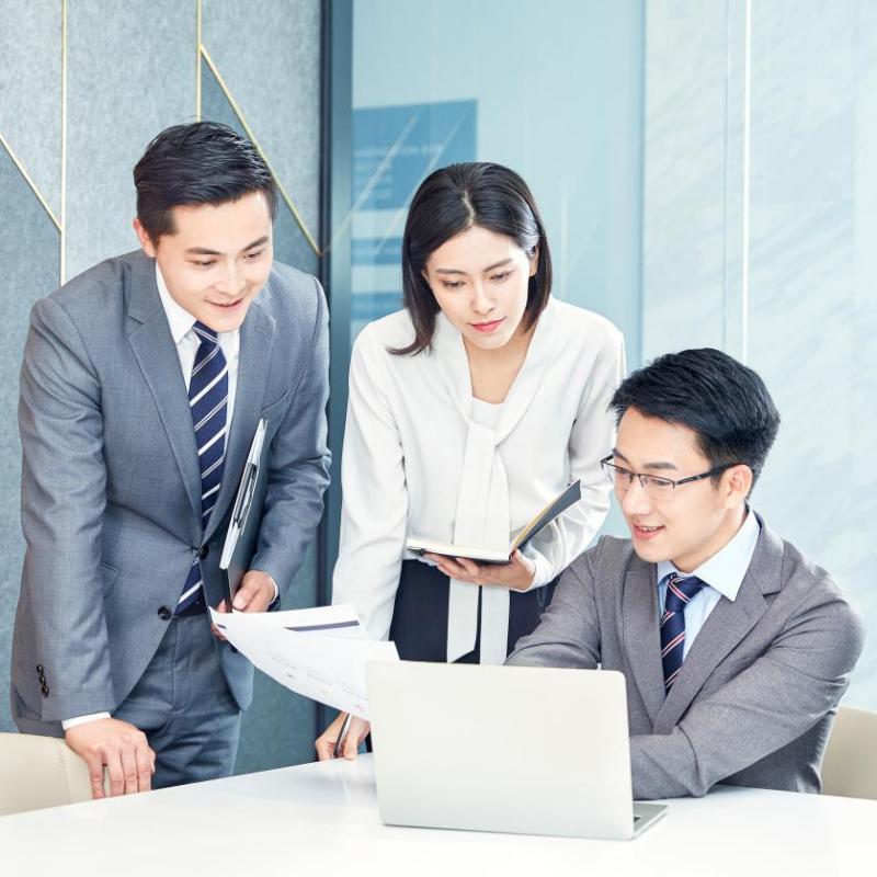 Professional hotel management team reviewing procurement checklists and timelines on a laptop during pre-opening planning.jpg