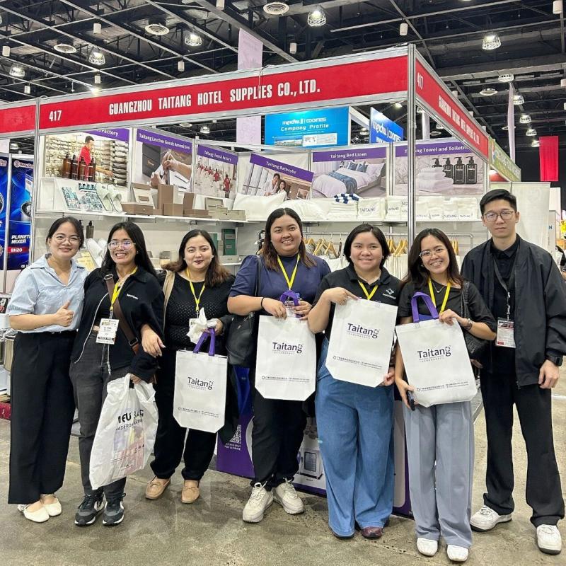 Hospitality procurement clients holding Taitang gift bags after sourcing hotel OS&E at the SMX Convention Center Manila.jpg