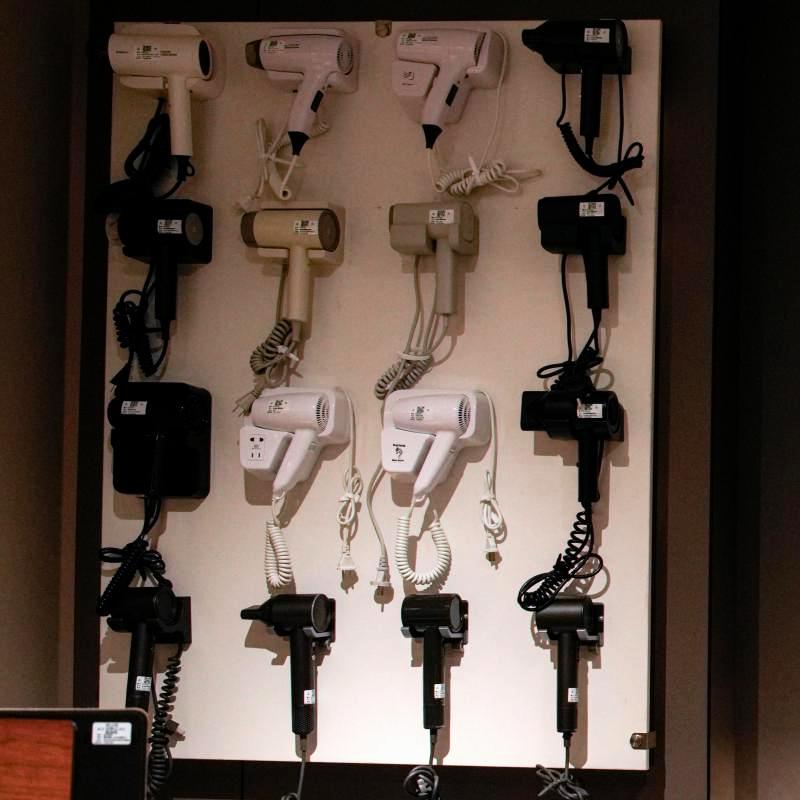 Taitang commercial hotel hair dryer showroom display featuring various wall-mounted and compact guest room models.JPG