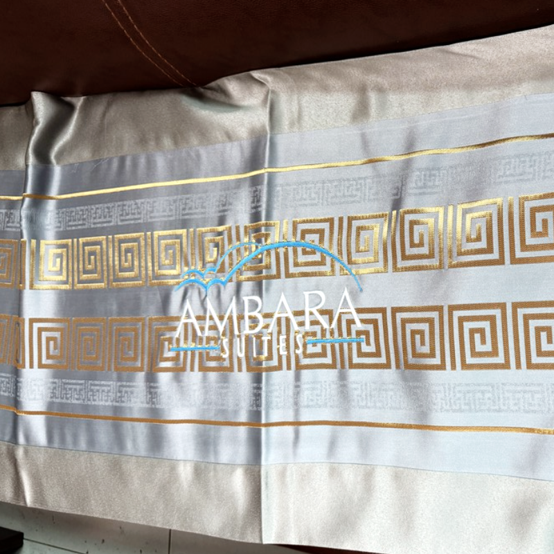 Custom ice-blue jacquard hotel bed runner featuring gold geometric border pattern and embroidered logo.png