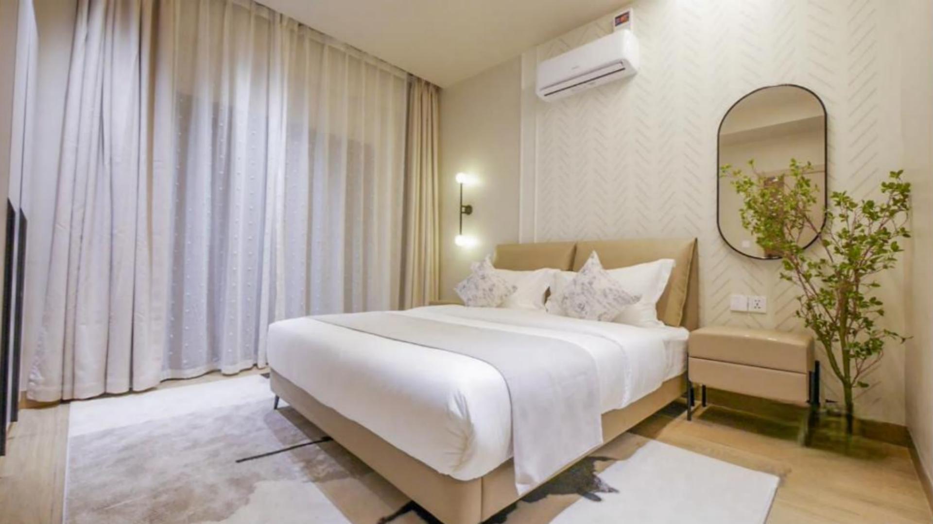 Contemporary 5-star master bedroom interior inside a luxury serviced apartment, featuring a neatly dressed king bed with wholesale 5 star hotel bedding from Taitang.jpg