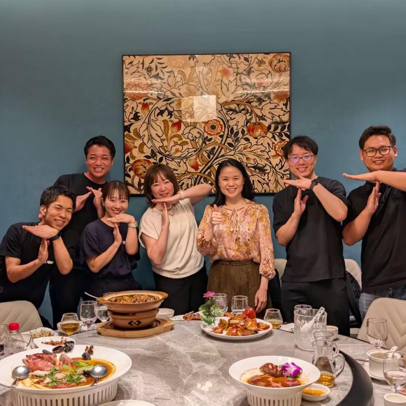 Taitang team and Minn Oku Asakusa procurement clients making the TT hand gesture during a successful partnership celebration.jpg