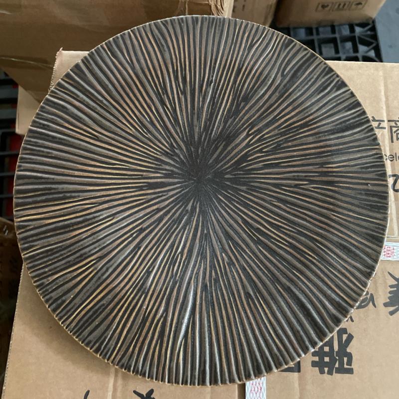 Custom dark-glazed commercial ceramic dinner plate with an etched radial sunburst pattern.JPG