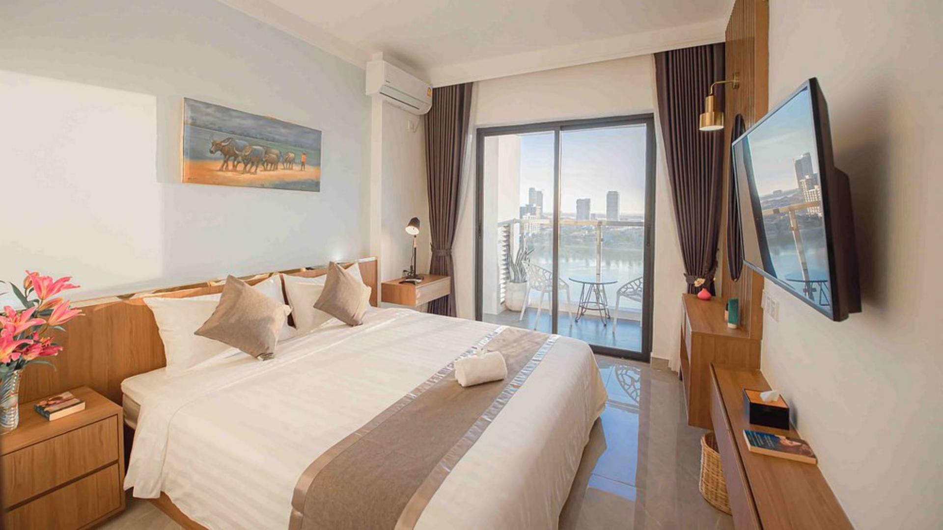 Superior king guestroom interior with balcony river view and plush white bedding at M9 Kirirom Hotel.jpg