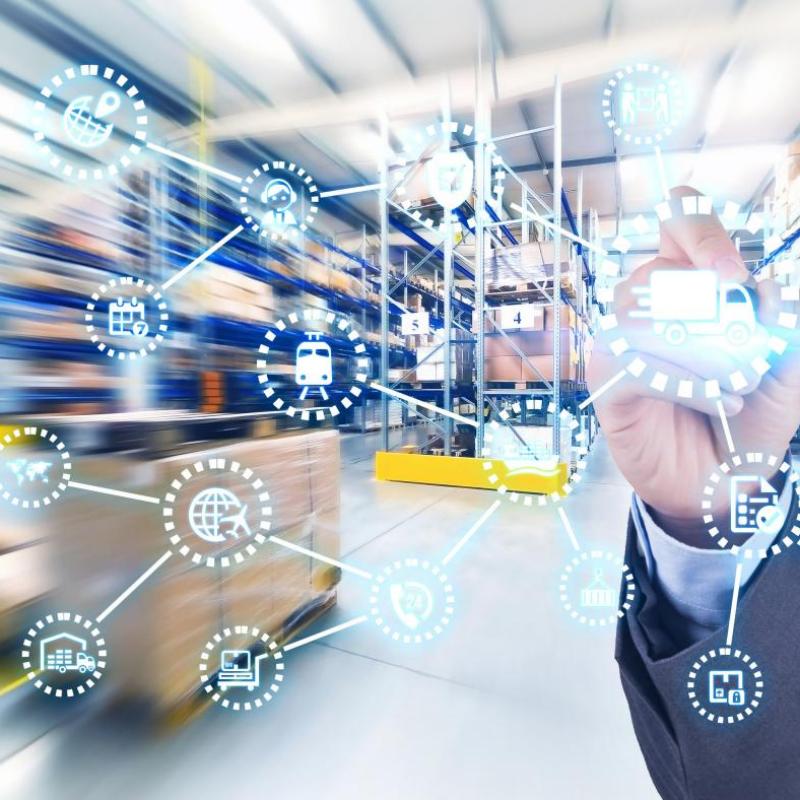 Person interacting with a digital network graphic over a warehouse background, showcasing hotel supply chain and logistics management.jpg