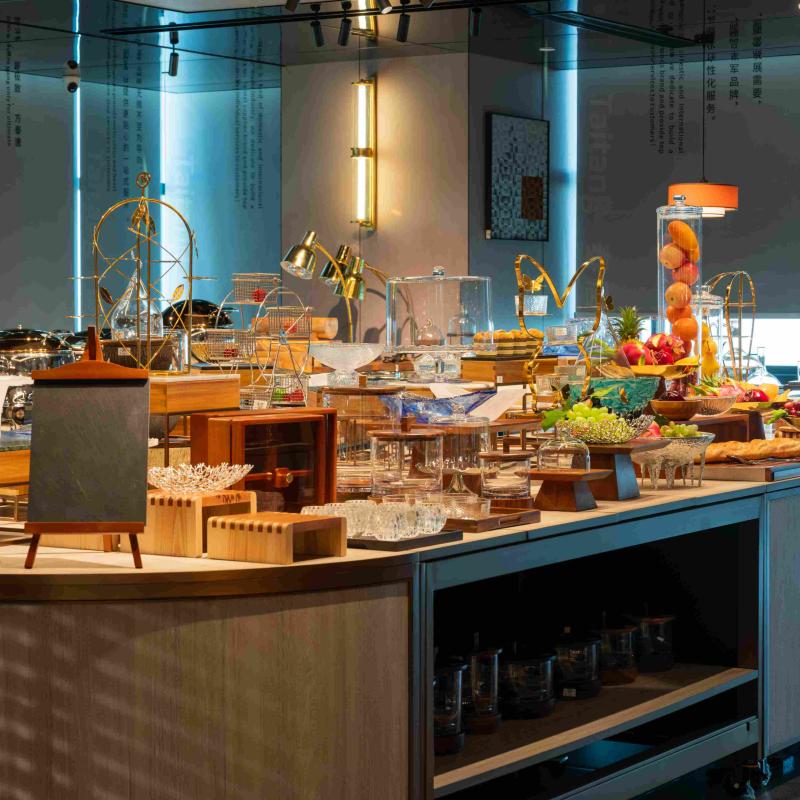Hotel buffet setup with elegant food risers, glass displays, and fresh fruit presentations highlighting luxury dining presentation.jpg