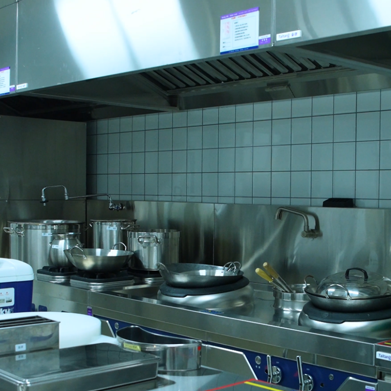 Taitang commercial hot kitchen cook station featuring heavy-duty wok ranges, stockpot stoves, and stainless steel exhaust hoods..png
