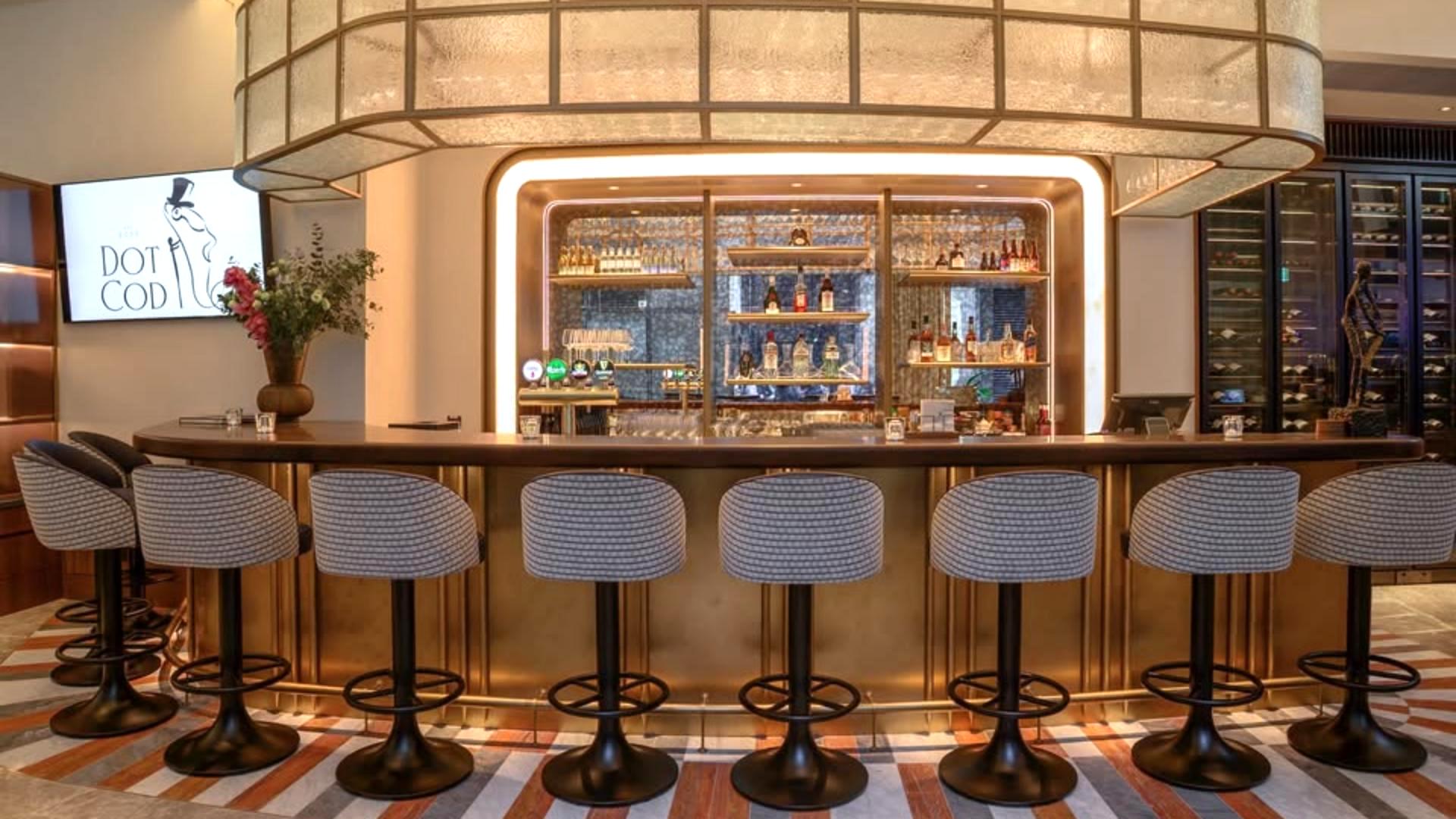 Luxury illuminated bar counter and high leather barstools inside Dot Cod European seafood restaurant.jpg