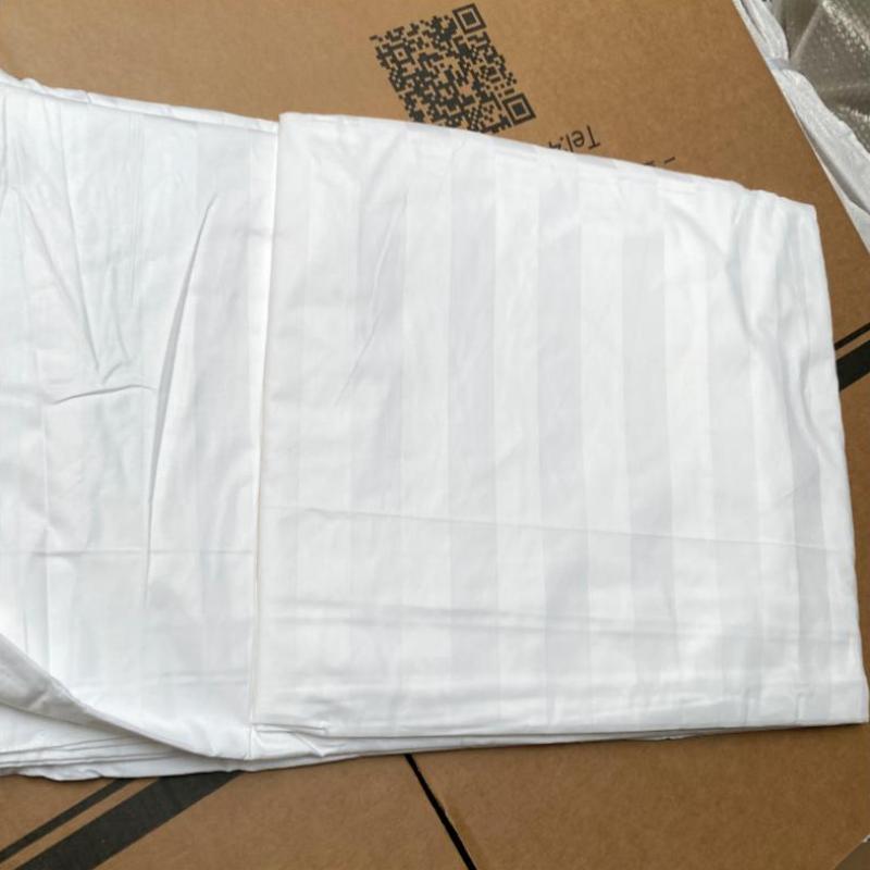 Close-up quality inspection of Taitang high-thread-count white satin stripe hotel bed sheets and duvet covers.JPG