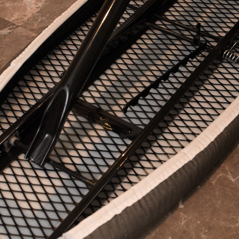 Underside structural detail of Taitang hotel ironing board highlighting the steam-permeable expanded steel mesh deck..png