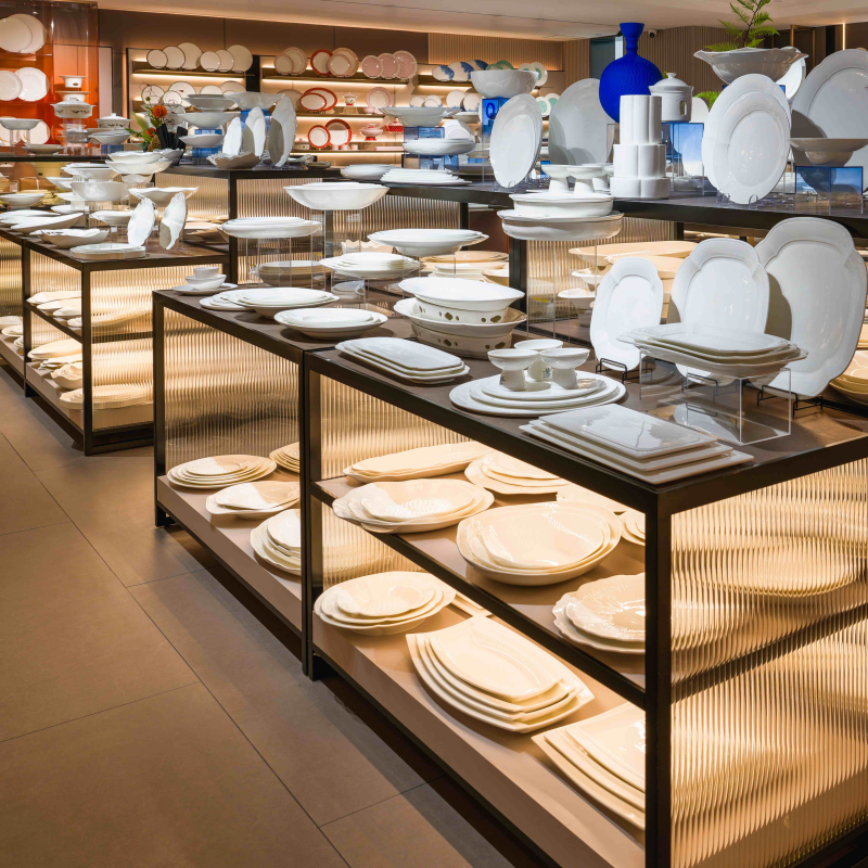 Extensive wholesale hotel ceramic tableware arrays and vitrified porcelain plates showcased on multi-level display stands for hospitality purchasing managers.jpg