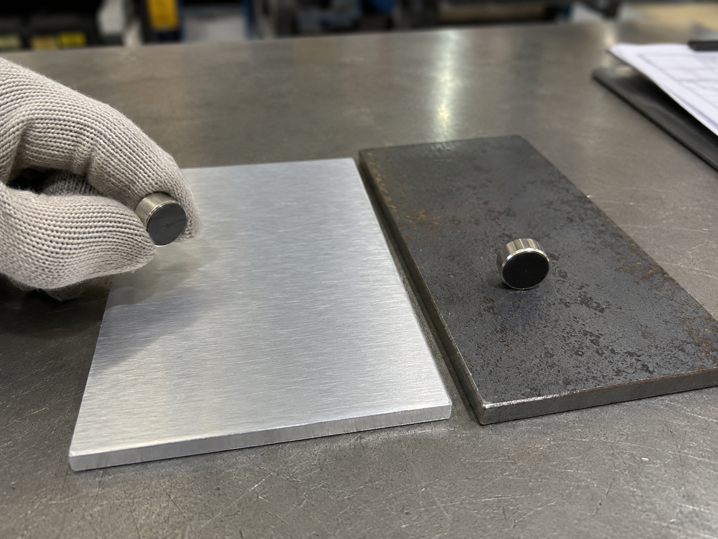 Aluminum and steel samples compared with a magnet during material inspection
