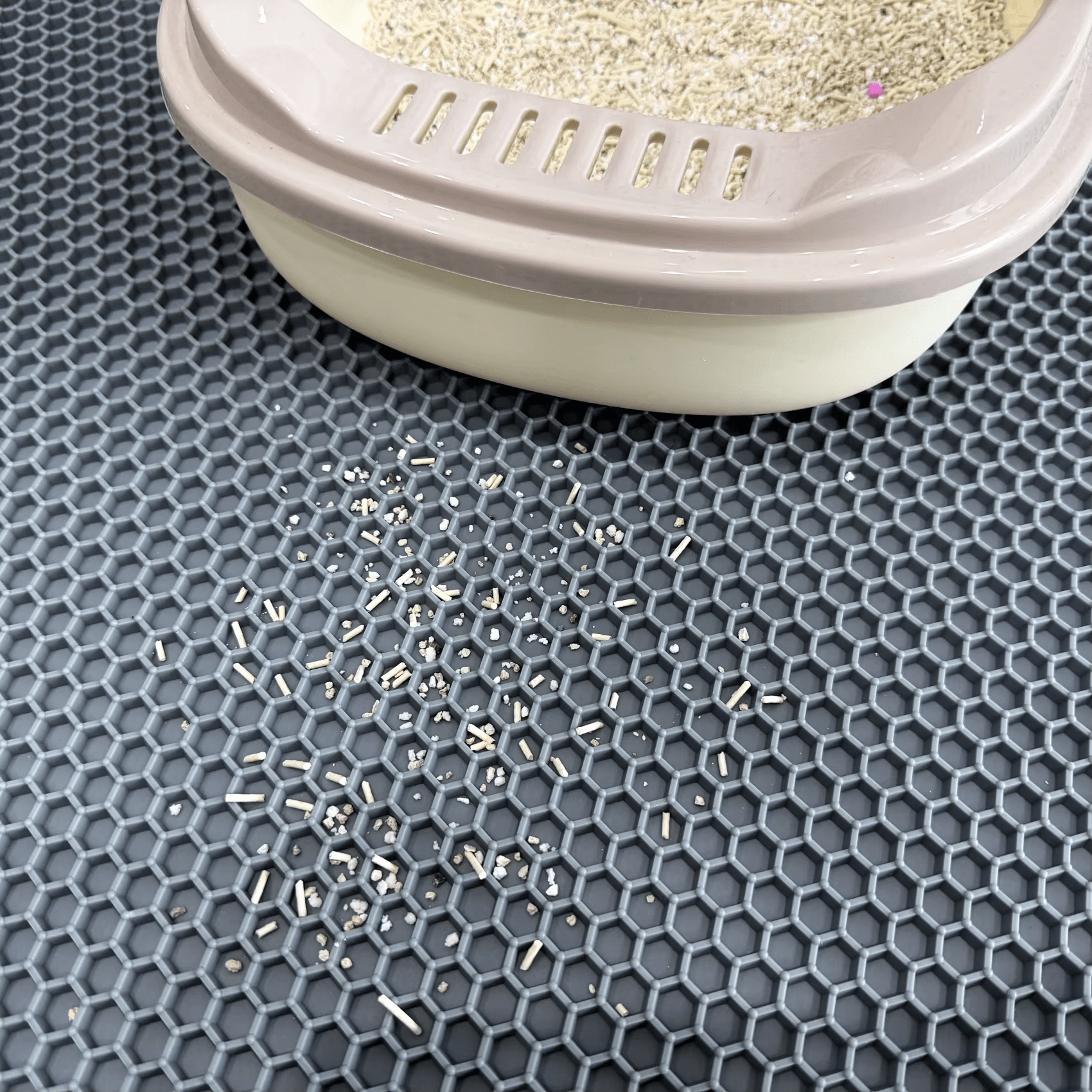 Honeycomb rubber cat litter mat texture captures scattered litter