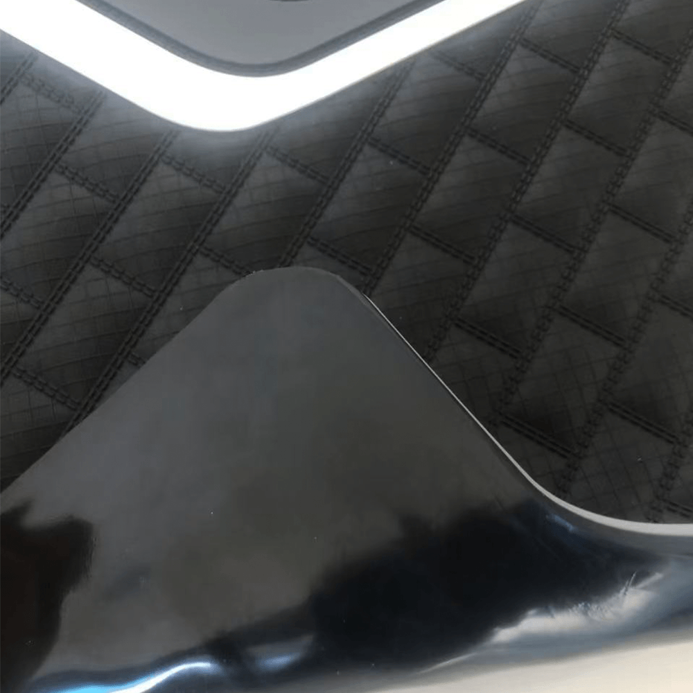 Close-up view of flexible rubber car mat surface with elastic material properties
