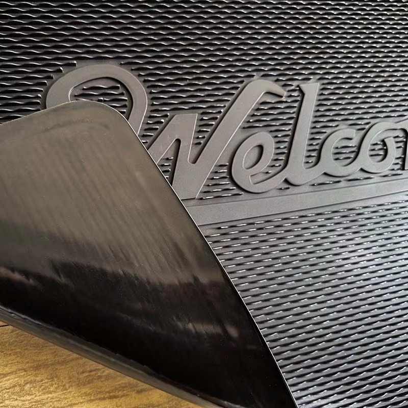 Smooth flat rubber backing of heavy duty entrance door mat.png