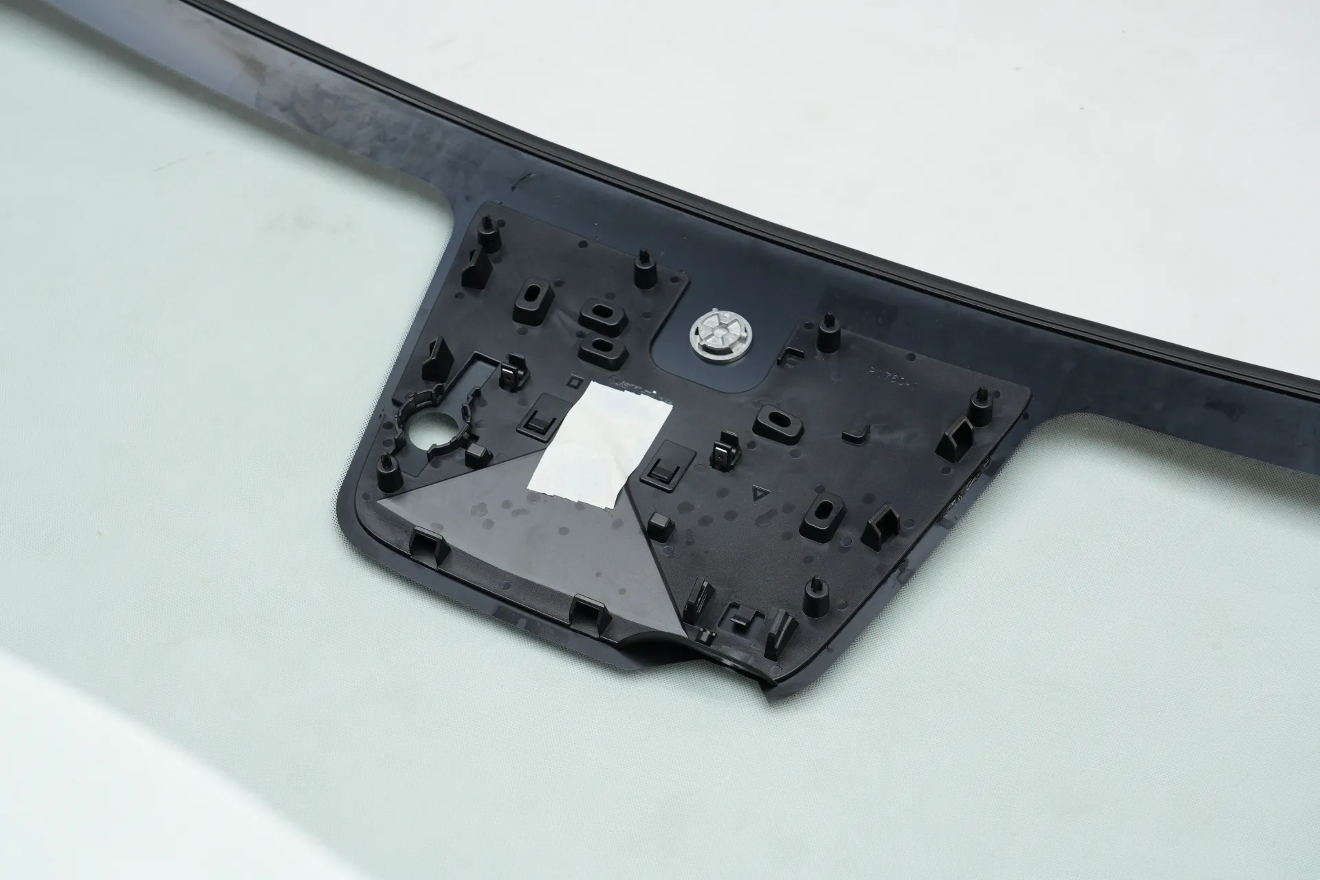ADAS camera and rain sensor mounting area on a luxury car windshield.webp