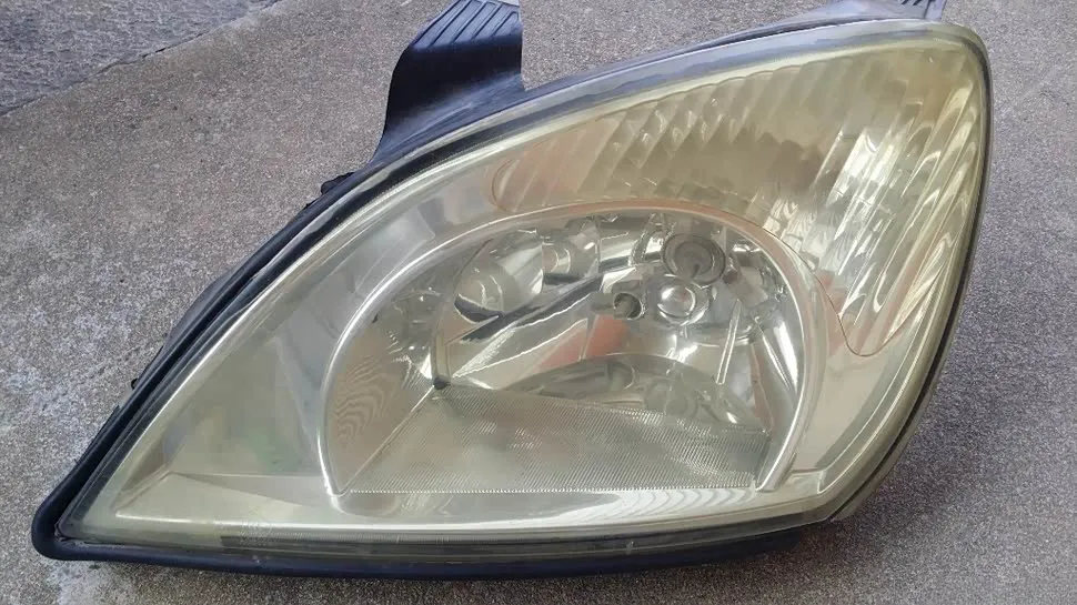 Yellowed headlight lens (common wear issue on used headlights).webp