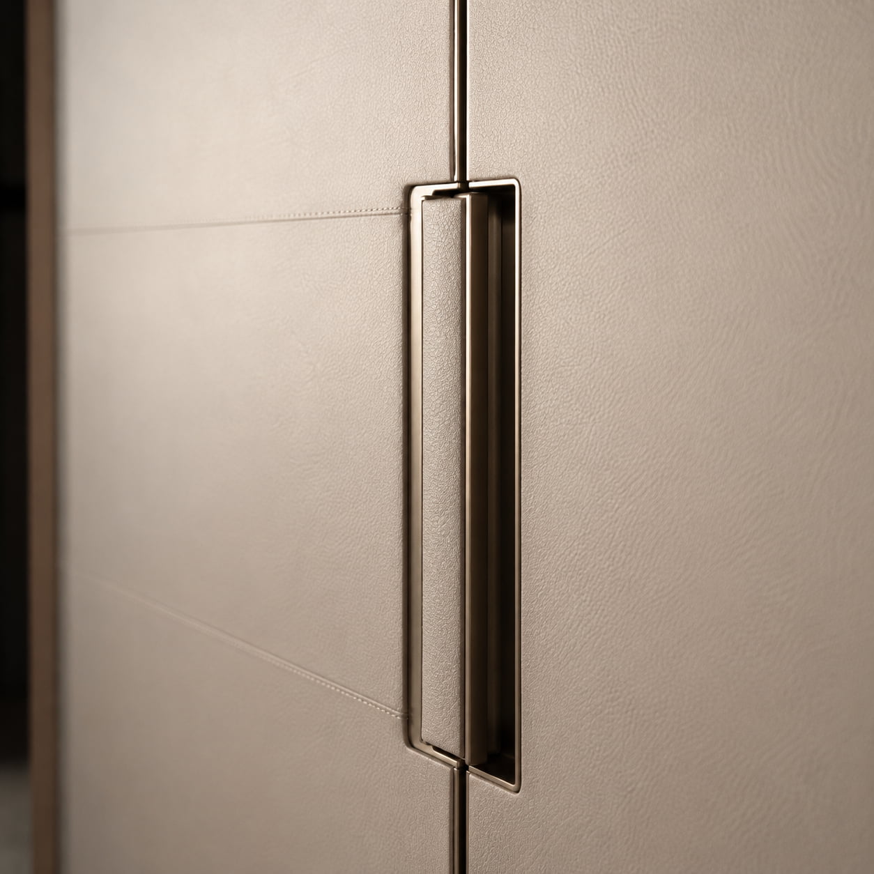 Recessed metal handle integrated into leather wardrobe door