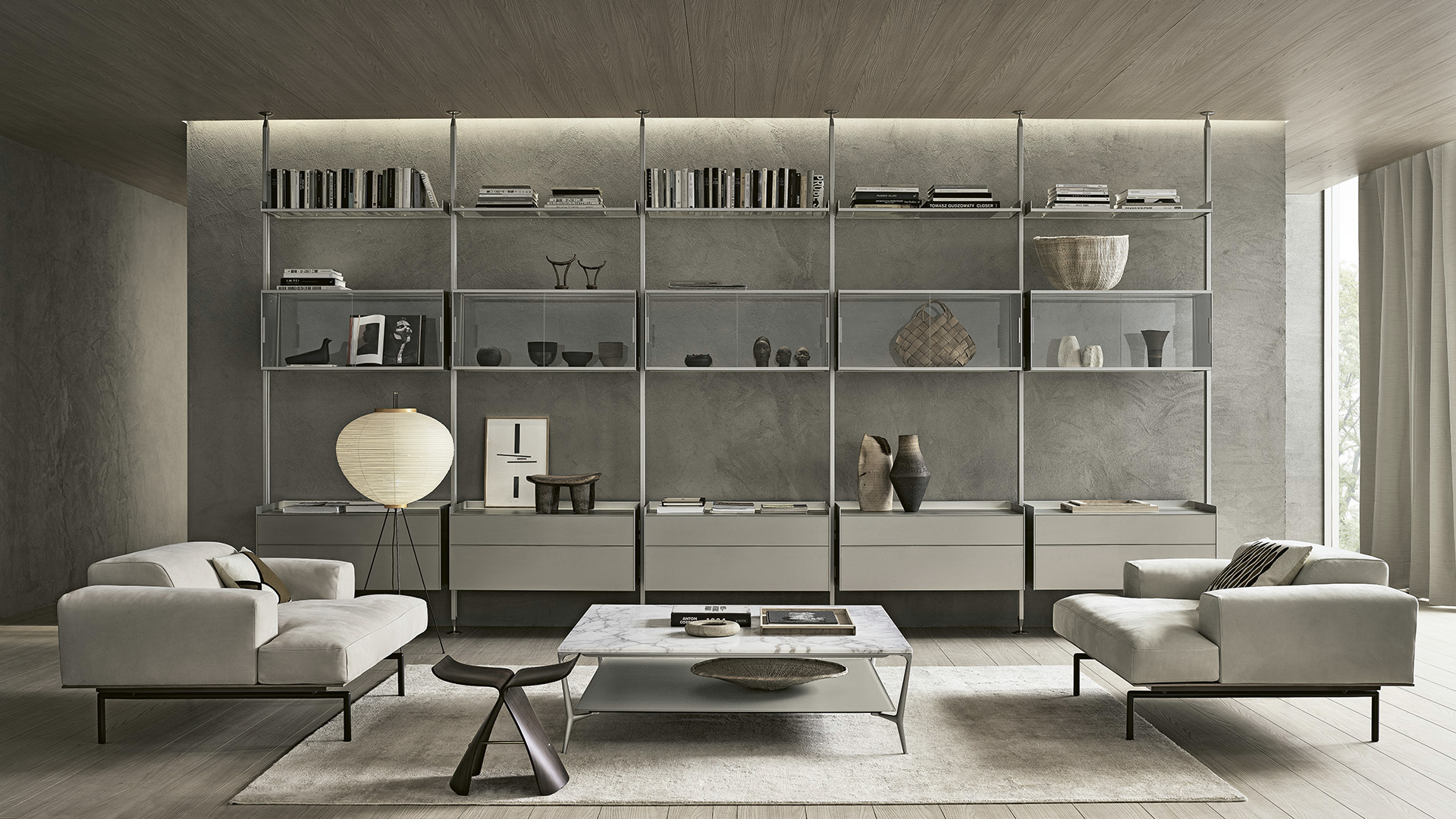 Floor to ceiling modular bookshelf wall in a luxury living room