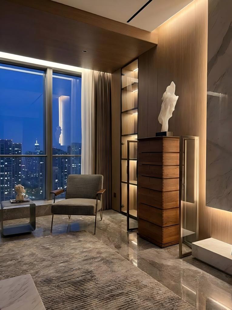 Seven-drawer glass collector cabinet illuminated by integrated warm LED lighting at night